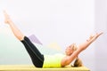 Beautiful pilates instructor with yellow yoga mat