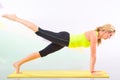 Beautiful pilates instructor with yellow yoga mat