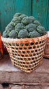 beautiful pile of fresh green broccoli in a woven bamboo basket