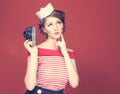 Beautiful pin-up girl holding in his hand a vintage camera Royalty Free Stock Photo