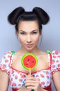 Beautiful pin-up girl holding sweet lollipop Royalty Free Stock Photo