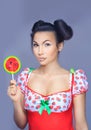 Beautiful pin-up girl holding sweet lollipop Royalty Free Stock Photo