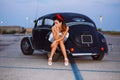 Beautiful pin-up girl posing with hot road car Royalty Free Stock Photo