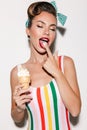 Beautiful pin up woman eating ice cream. Royalty Free Stock Photo