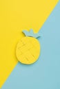 Beautiful pineapple figurine on a yellow and blue background. Minimal summer concept