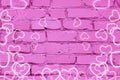 Beautiful pink against a brick wall with hearts