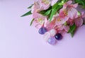 Beautiful pink alstroemeria flowers and semi-precious stones rose quartz and amethyst lie on a pink background. Copy space