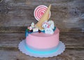 Beautiful pink baby cake with candy and marshmallow
