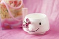 Beautiful pink background with white Cup and butterfly
