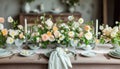 Beautiful pink and beige colors morning table decoration with lace tablecloth and napkins, pinky rose flowers, silver tableware