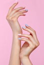 Beautiful pink and blue manicure with crystals on female hand. Close-up. Royalty Free Stock Photo