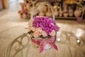 Beautiful pink bouquet of mixed flowers in basket on table Royalty Free Stock Photo