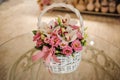 Beautiful pink bouquet of mixed flowers in basket on table Royalty Free Stock Photo