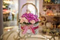 Beautiful pink bouquet of mixed flowers in basket on table Royalty Free Stock Photo