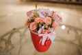 Beautiful pink bouquet of mixed flowers in basket on table Royalty Free Stock Photo