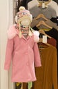 Beautiful pink coat for children worn by mannequin