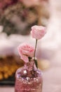 Beautiful pink flowers in bouquets on the batle in restaurant. Elegant decoration for the celebration. Close-up