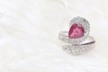 Pink gemstone on diamond ring