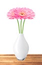 Beautiful pink gerbera daisy flowers in vase on wooden table Royalty Free Stock Photo