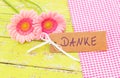 Pink flowers and card with german word, Danke, means thank you