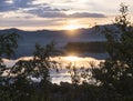 Beautiful pink golden light sunrise at lake dam on river Lulealven in Saltoluokta in Sweden Lapland. Blue mountains Royalty Free Stock Photo