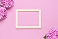 Beautiful pink hydrangea flowers, white wooden photo frames on pink background top view flat lay copy space. Flower card. Holiday Royalty Free Stock Photo