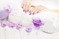 Beautiful pink manicure with orchid and towel on the white wooden table. spa Royalty Free Stock Photo