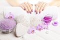 Beautiful pink manicure with orchid and towel on the white wooden table. spa Royalty Free Stock Photo