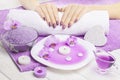 Beautiful pink manicure with orchid and towel on the white wooden table. spa Royalty Free Stock Photo