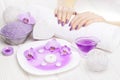 Beautiful pink manicure with orchid and towel on the white wooden table. spa Royalty Free Stock Photo