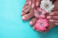 Beautiful pink manicure and pedicure with flowers Royalty Free Stock Photo