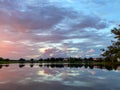 Beautiful pink, orange and blue sunset reflecting on a lake in a suburban Royalty Free Stock Photo