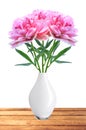 Beautiful pink peony flowers in white vase on table Royalty Free Stock Photo