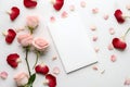 Beautiful pink red rose and petals stalk scattered isolated with note card on white background Royalty Free Stock Photo