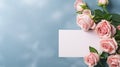 Beautiful pink rose flower bouquet and mockup blank note paper on blue background, congratulations and anniversary concept,