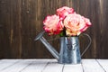 Beautiful pink rose in a tin watering can Royalty Free Stock Photo