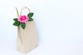 Beautiful pink roses in brown paper bag isolated on the white b Royalty Free Stock Photo