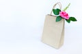 Beautiful pink roses in brown paper bag isolated on the white b Royalty Free Stock Photo