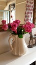 Beautiful pink roses in a cream jug Royalty Free Stock Photo