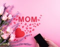 Beautiful pink roses, red hearts and mobile with Mothers day message . Royalty Free Stock Photo
