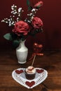 Beautiful pink roses in a vase accented with Baby`s Breath flowers, heart shaped white dollie with a decorated cup cake with a he