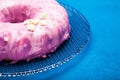 A beautiful pink round cake on a blue table, close-up Royalty Free Stock Photo