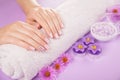 Beautiful pink and silver manicure with flowers and spa essentials Royalty Free Stock Photo