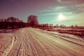 Beautiful pink sunrise over a snowy country road Royalty Free Stock Photo