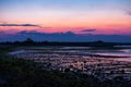 Beautiful pink sunset light on beach landscape silhouette