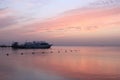 Beautiful pink sunset on the sea. Boats on the water. Warm rays of sun light. Red sea, Egypt Royalty Free Stock Photo