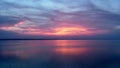 Beautiful pink sunset with sun rays over sea. Royalty Free Stock Photo