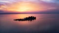 Beautiful pink sunset with sun rays over sea.