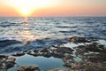 Beautiful pink sunset and water stones over Black sea rocky coastline in Crimea Royalty Free Stock Photo