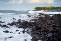 Beautiful pink tinted waves breaking on a rocky beach at sunrise on east coast of Big Island of Hawaii Royalty Free Stock Photo